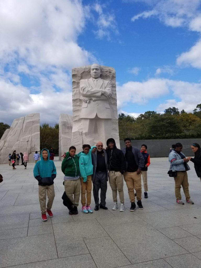 A group of people standing in front of the martin luther king jr. Memorial